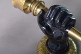 Pair of Art Deco solid brass wall sconces from the 1930s featuring a fist holding torch design, ideal for vintage and antique home décor.