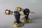 Pair of Art Deco solid brass wall sconces from the 1930s featuring a fist holding torch design, ideal for vintage and antique home décor.
