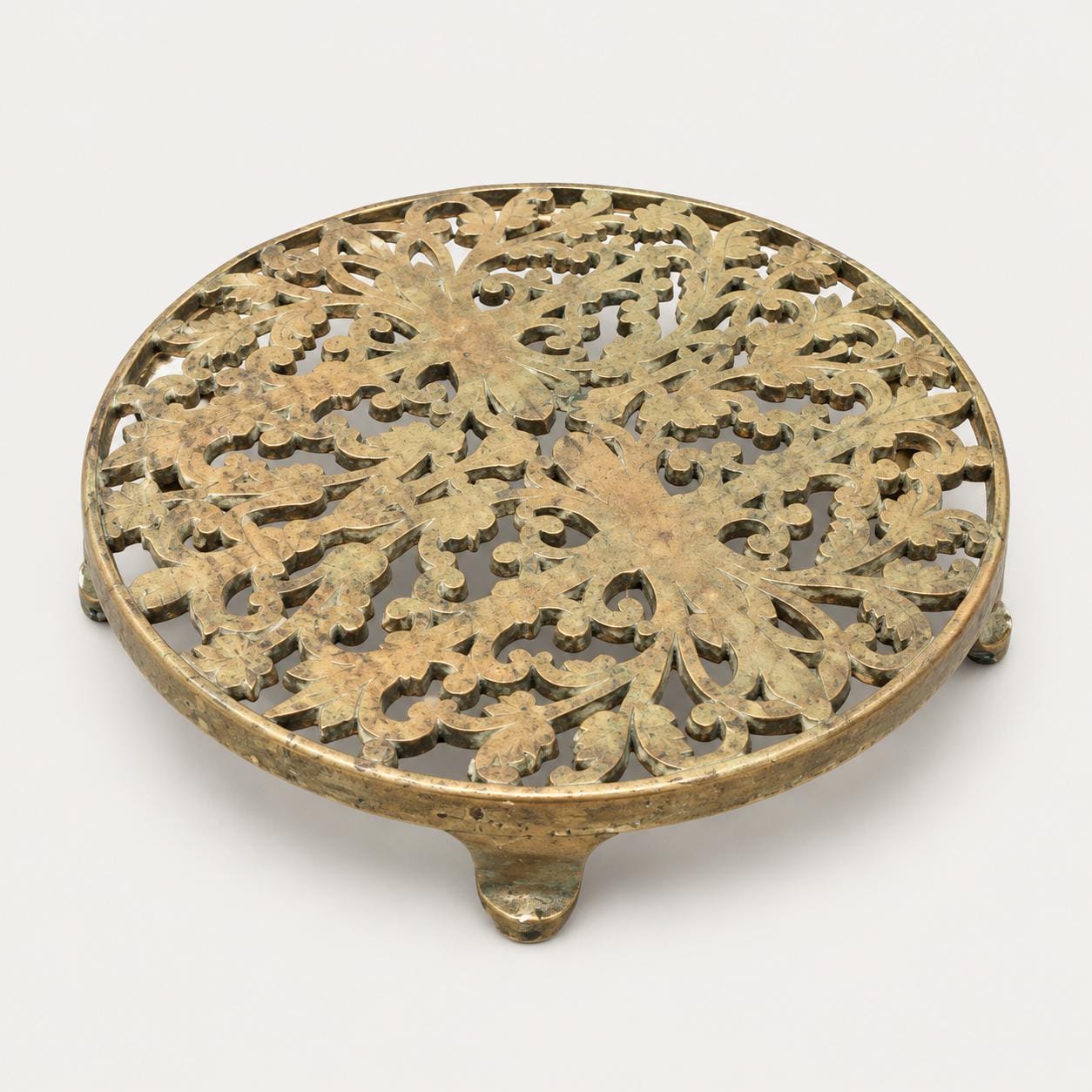 Vintage Pierced Brass-Toned Round Trivet, Footed Openwork Floral Design