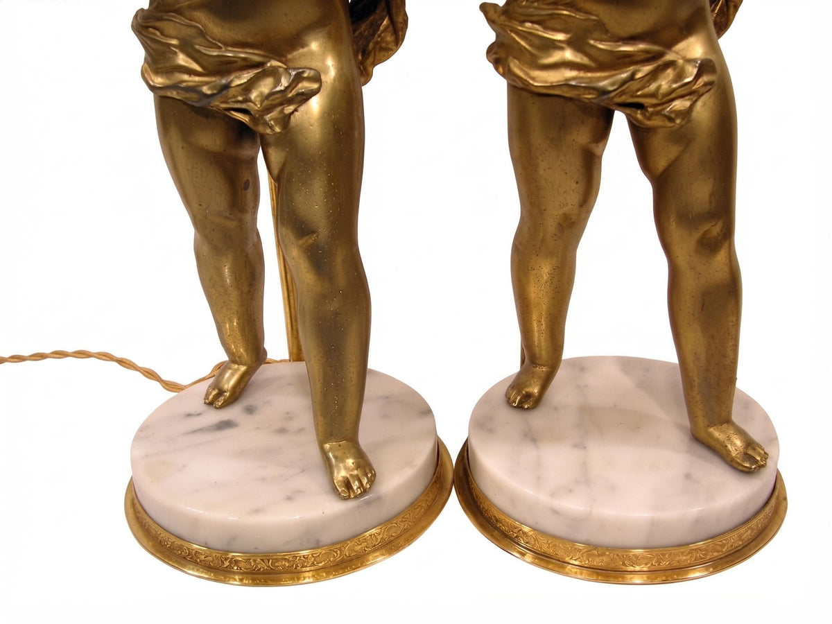 Pair of French Gilt Putti Table Lamps, Winged Cherub Figures on White Marble Bases — France, Early 20th Century