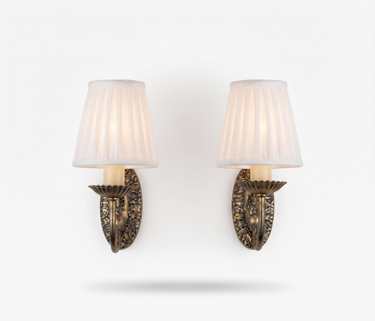 Pair of Vintage Silvered Metal Wall Sconces — Pierced Oval Backplate with Scrolled Ring Arm, Pleated Shades