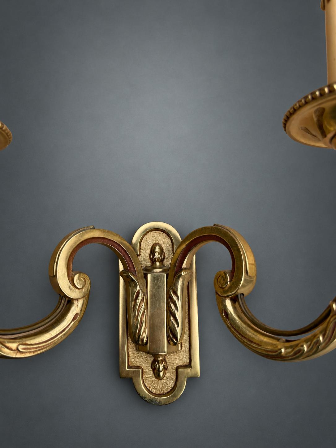 Pair of Gilt Metal Two-Arm Wall Sconces with Candle-Form Covers and Scrolled Arms