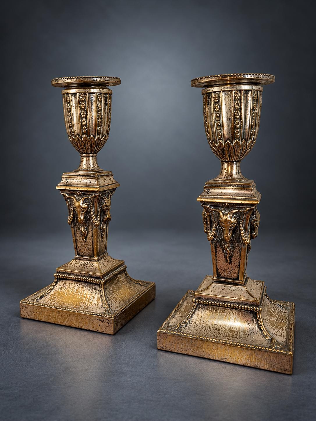 Pair of Neoclassical Candlesticks, Silver-Tone Metal with Ram's Heads and Garlands, Fluted Urn Sconces, Warm Worn Finish