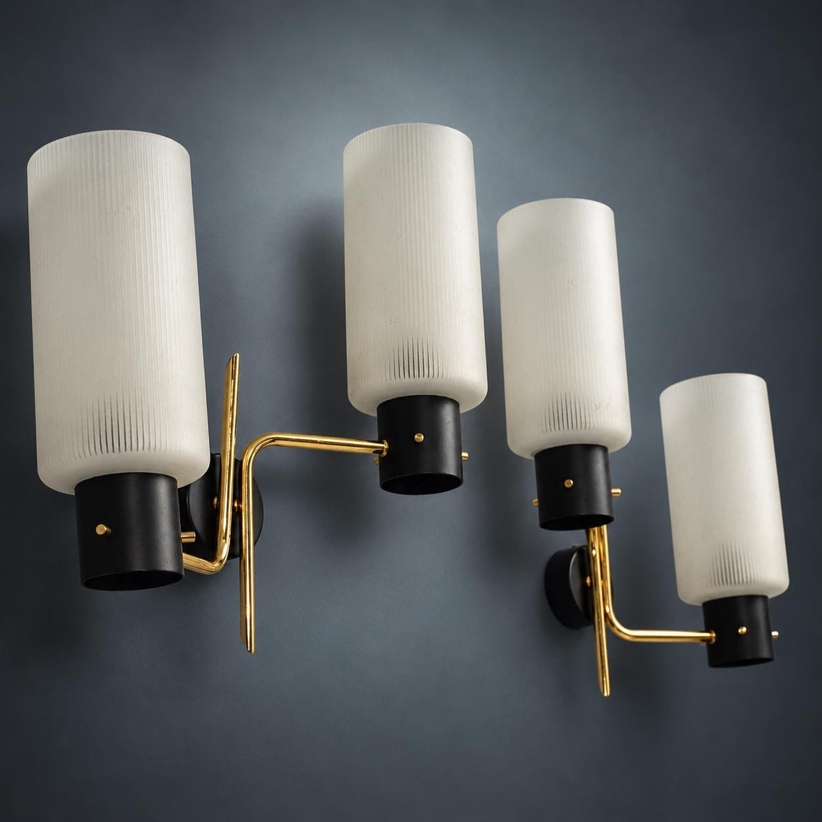 Pair of Mid-Century Double Wall Sconces, Ribbed Milk Glass Cylinders, Matte Black and Gold-Tone Metal Arms