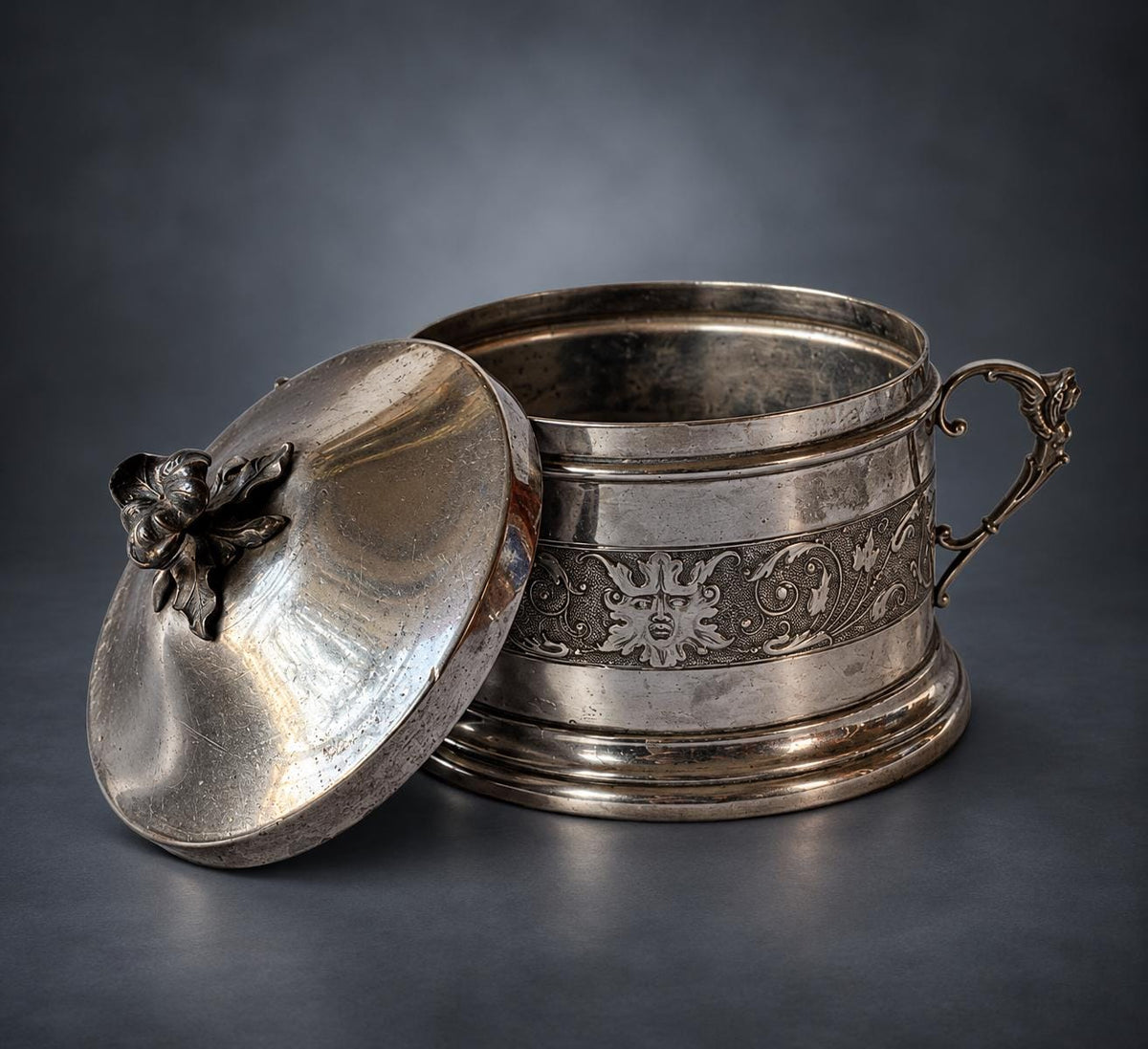 Lidded Bonbonnière in Silver-Tone Metal, Embossed Mask and Scroll Band, Figural Handles, Leaf Finial, Renaissance Revival Style
