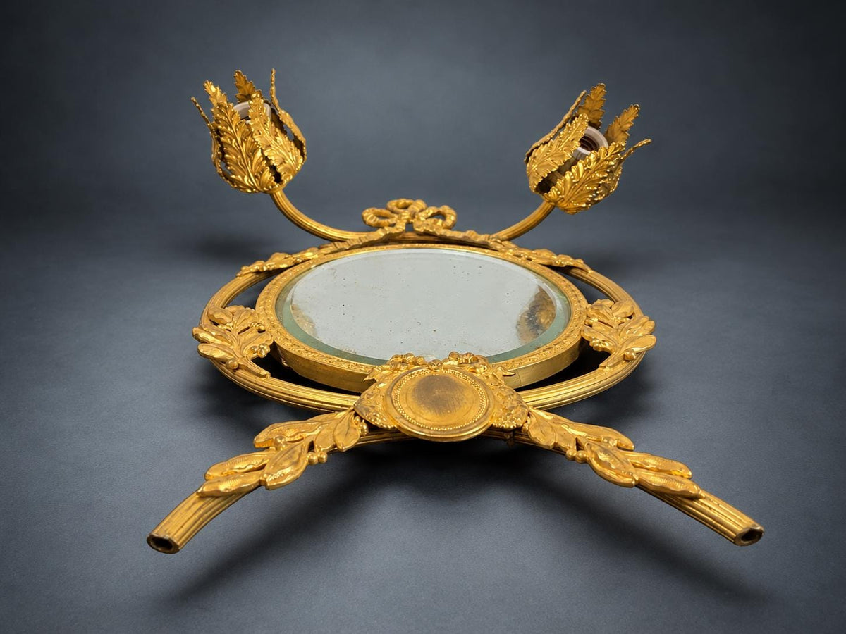 Louis XVI Style Mirrored Wall Sconce, Gilt Metal Girandole with Bevelled Oval Mirror, Ribbon Bow and Laurel, Two Lights
