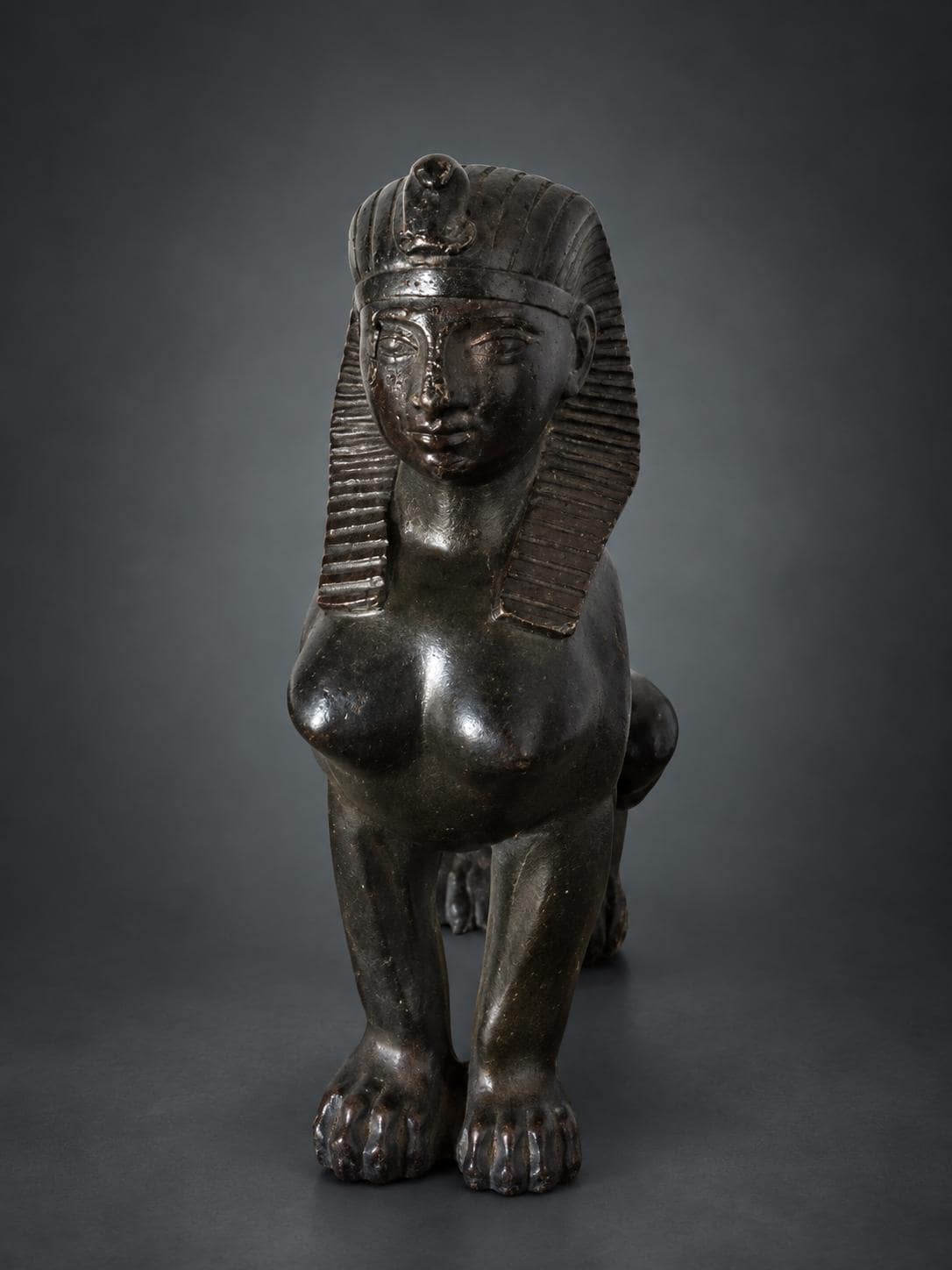 Egyptian Revival Style Seated Sphinx Figure, Dark Patinated Metal, Nemes Headdress, Former Clock or Furniture Mount