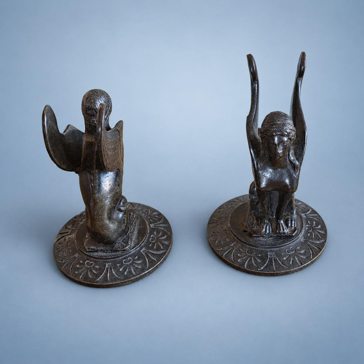 Vintage Pair of Neoclassical Style Winged Sphinx Figures, Patinated Metal on Palmette Bases, Sold as Bookends