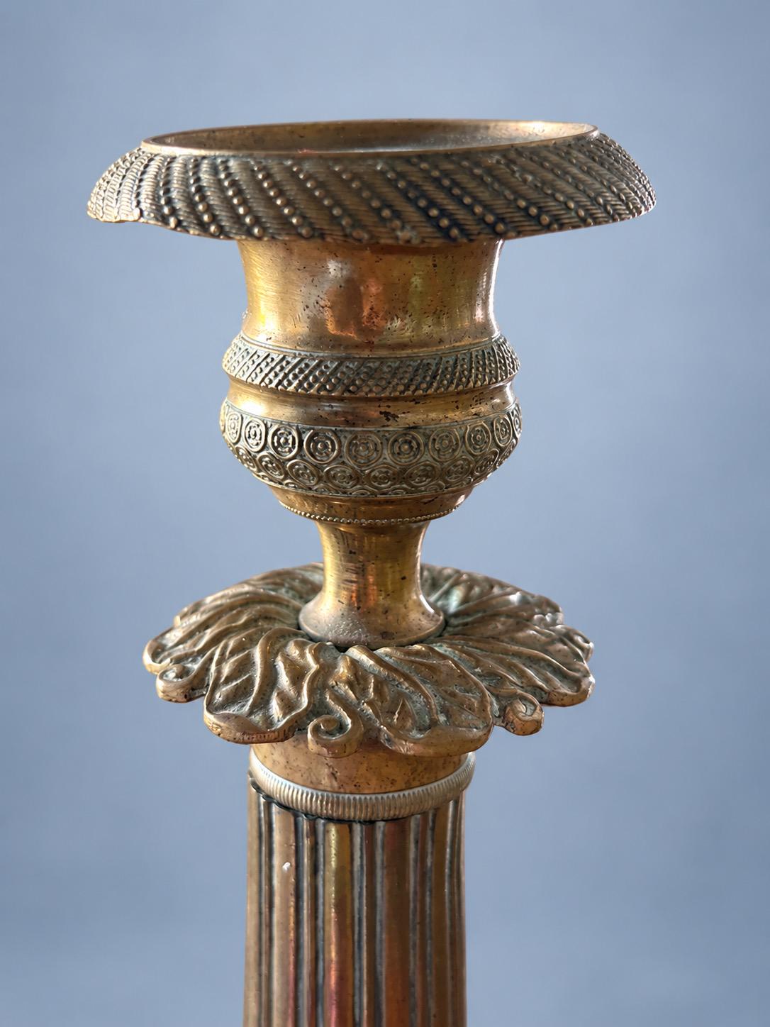 Vintage Pair of Empire Style Patinated Brass-Tone Candlesticks, Fluted Columns, Acanthus Collars and Foliate Bases