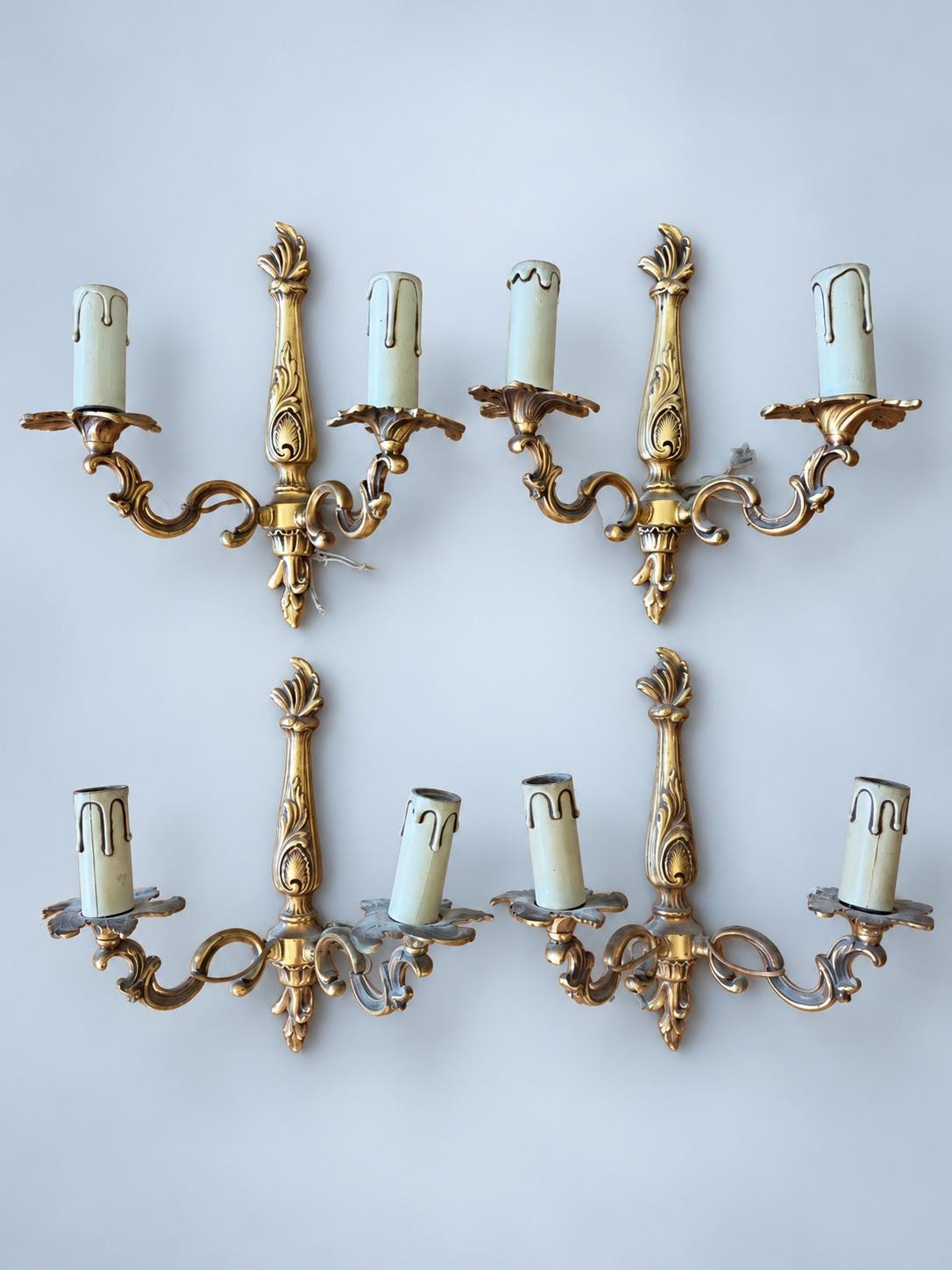 Vintage Set of Four Louis XV Style Brass-Tone Two-Arm Wall Sconces with Leaf-Shaped Drip Pans