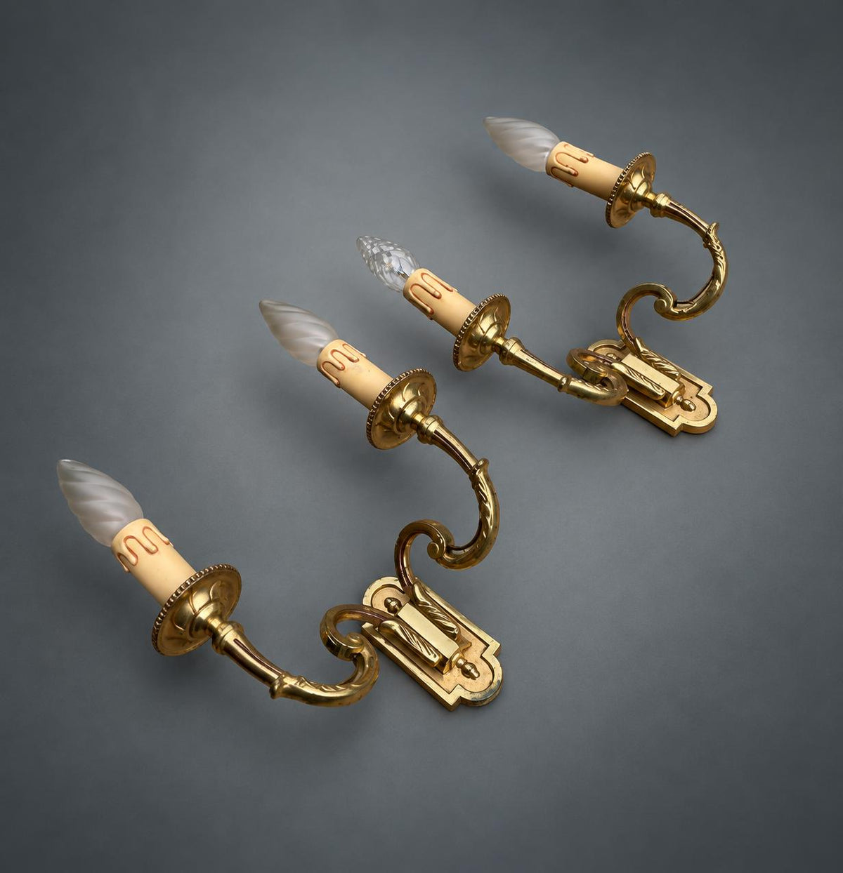 Pair of Gilt Metal Two-Arm Wall Sconces with Candle-Form Covers and Scrolled Arms