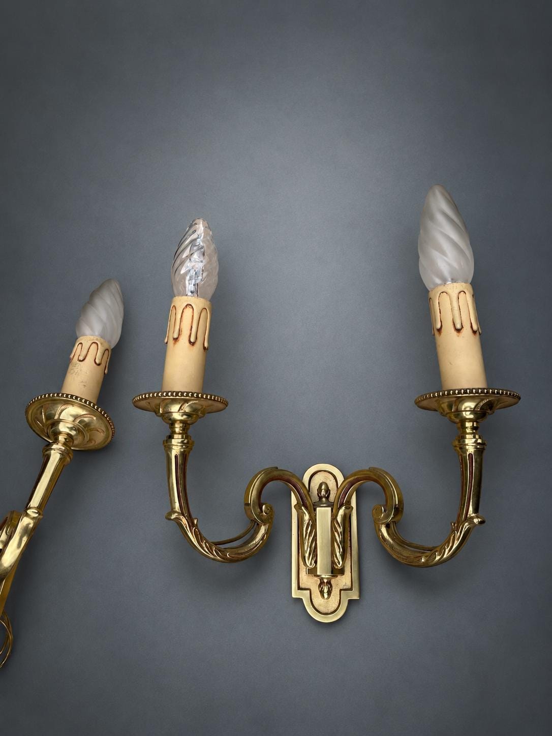 Pair of Gilt Metal Two-Arm Wall Sconces with Candle-Form Covers and Scrolled Arms