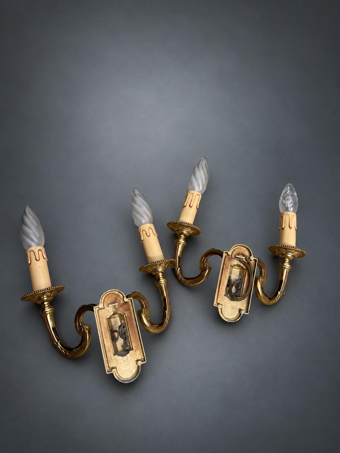 Pair of Gilt Metal Two-Arm Wall Sconces with Candle-Form Covers and Scrolled Arms