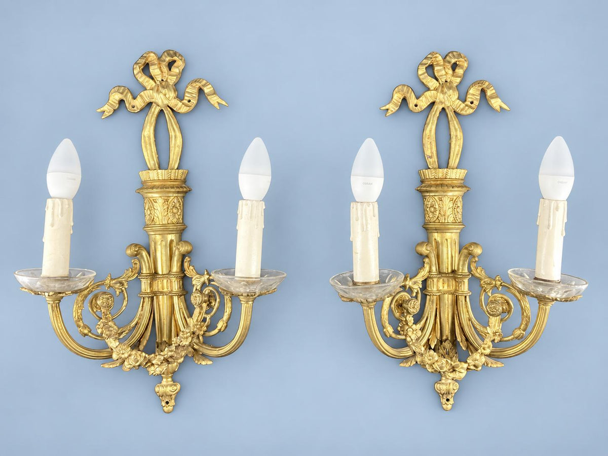 Vintage Pair of Louis XVI Style Brass-Tone Two-Arm Wall Sconces with Ribbon Bow, Flower Garlands and Glass Drip Pans