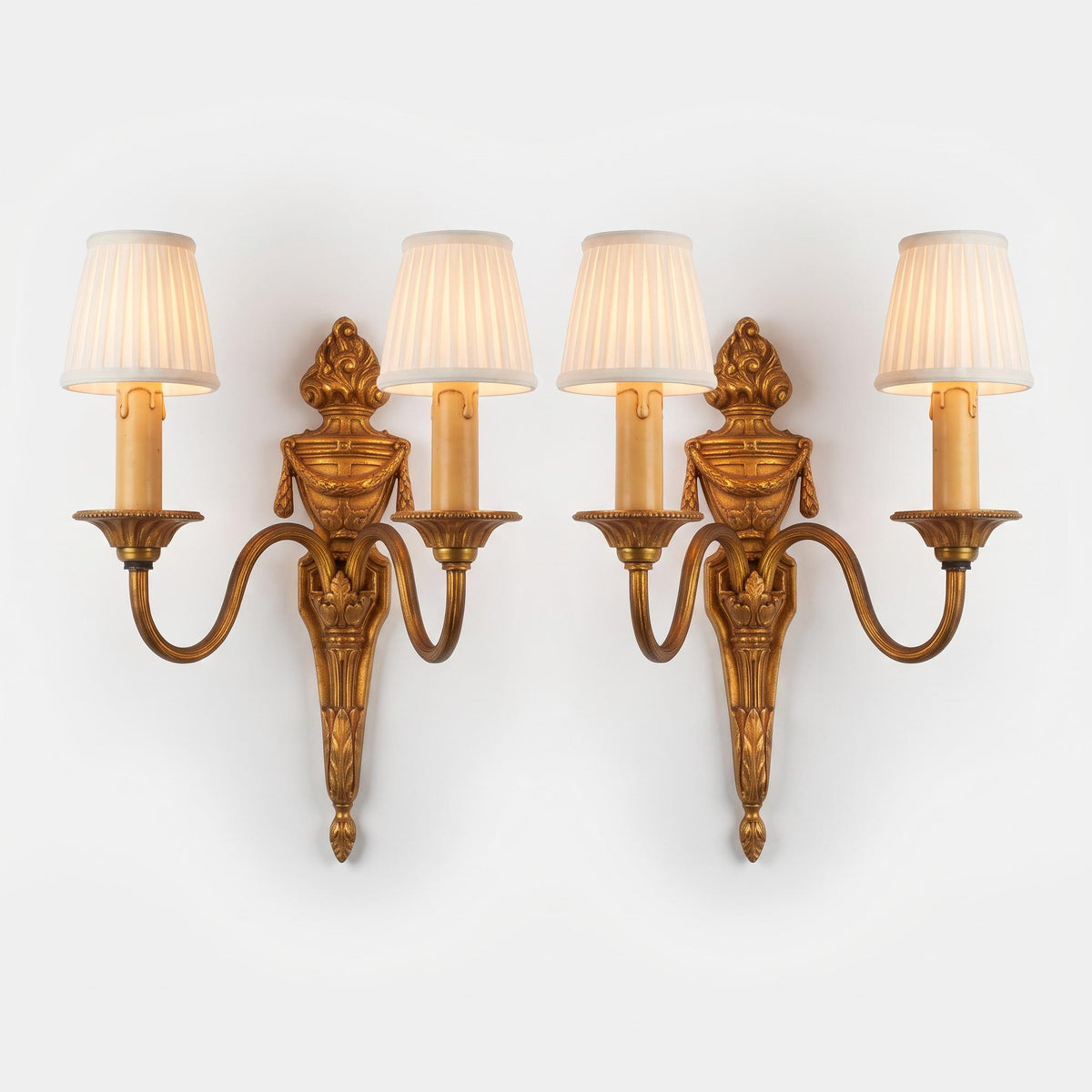 Vintage Pair of Louis XVI Style Two-Arm Gilt Metal Wall Sconces with Flaming Urns and Tasselled Swags