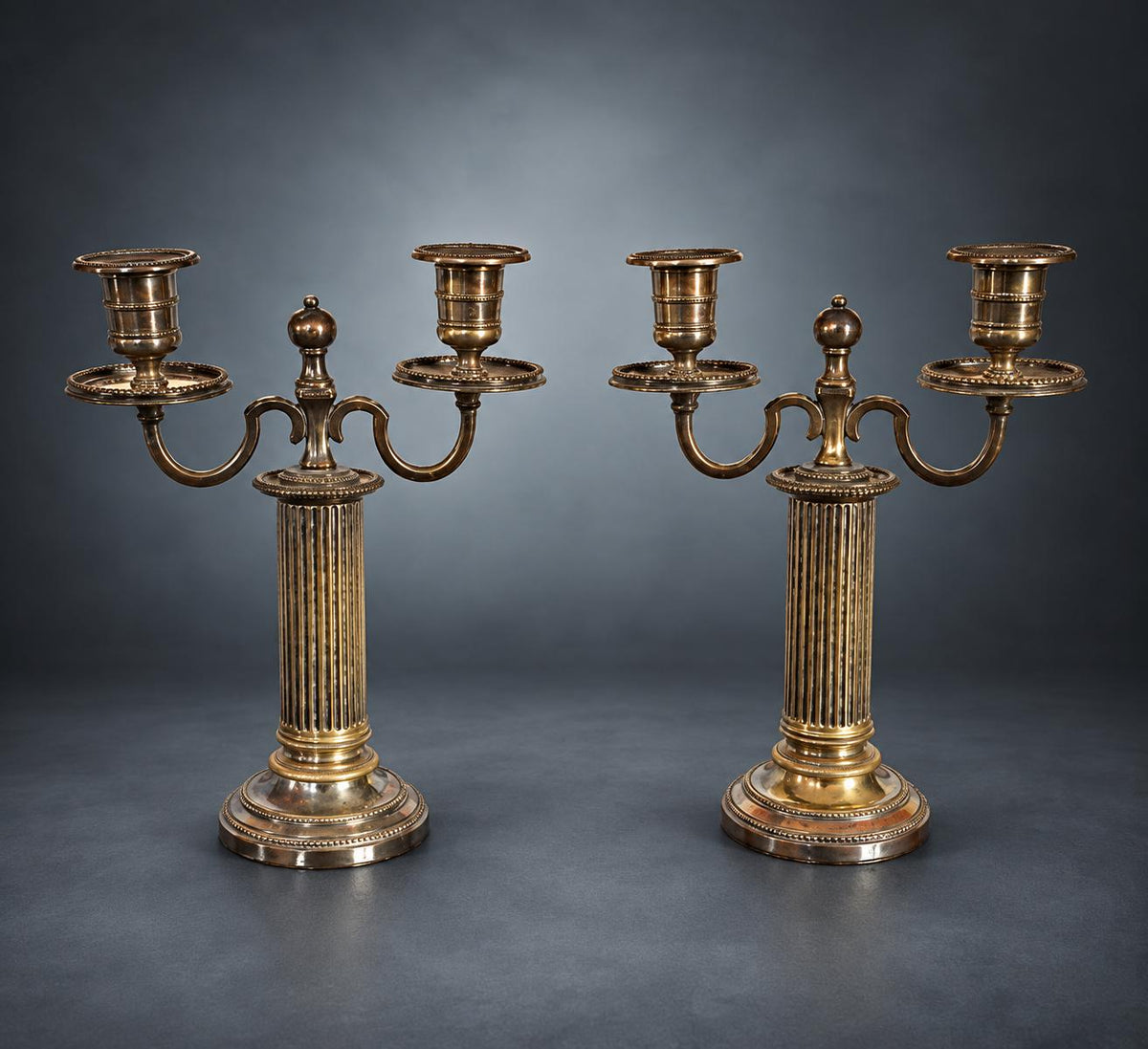 Pair of Louis XVI Style Two-Light Candelabra, Silver-Tone Metal, Fluted Columns, Beaded Round Bases, Urn Finials