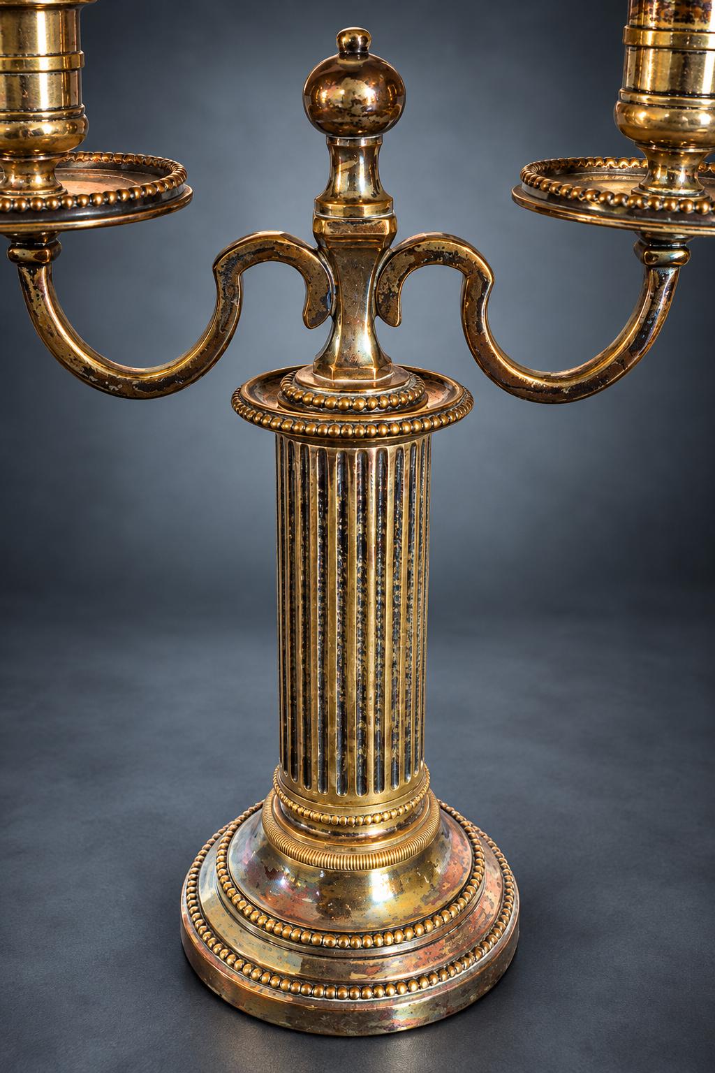 Pair of Louis XVI Style Two-Light Candelabra, Silver-Tone Metal, Fluted Columns, Beaded Round Bases, Urn Finials