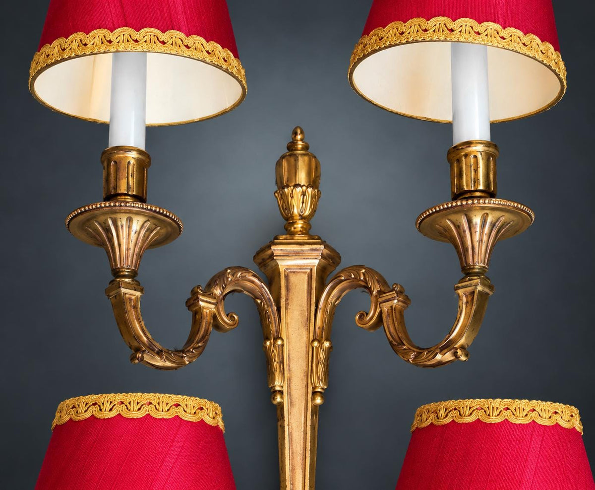 Pair of Louis XVI Style Two-Arm Wall Sconces, Gilt Metal with Urn Finials, Four Red Clip-On Shades with Gold Braid