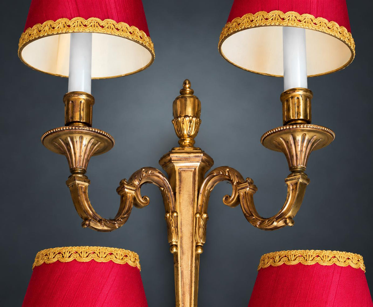 Pair of Louis XVI Style Two-Arm Wall Sconces, Gilt Metal with Urn Finials, Four Red Clip-On Shades with Gold Braid