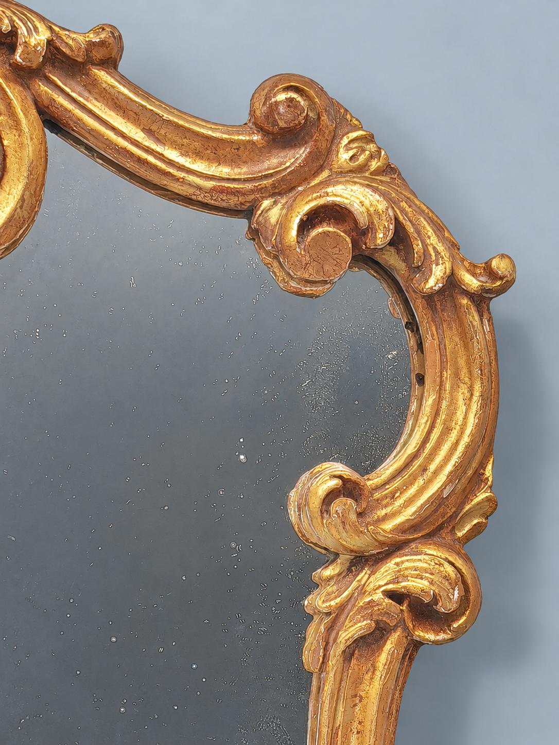 Vintage Rocaille Style Giltwood and Gilt Stucco Mirror, Shell Crest and Scrolls, Shaped Frame on Small Feet, 42 cm