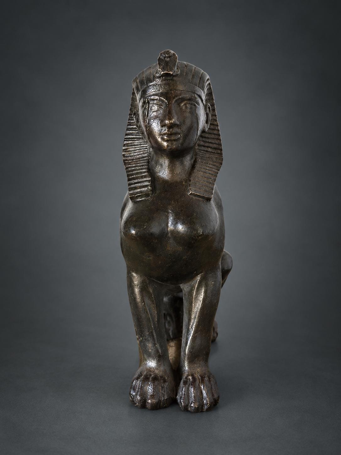 Egyptian Revival Style Seated Sphinx Figure, Dark Patinated Metal, Nemes Headdress, Former Clock or Furniture Mount