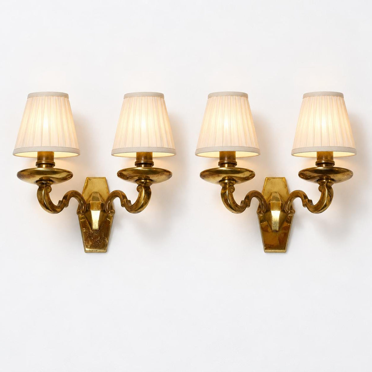 Vintage Pair of Louis XIV Style Polished Brass Wall Sconces, Faceted Backplates with Heavy Scroll Arms, Two Lights Each