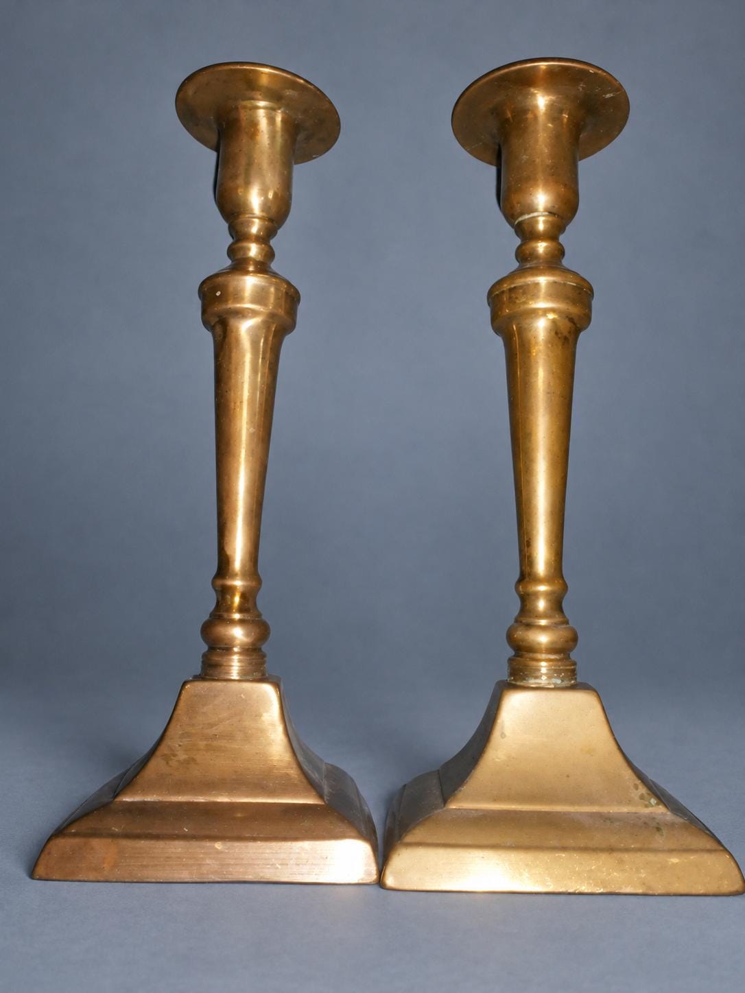 Vintage Pair of Neoclassical Style Candlesticks, Brass-Tone Metal with Tapered Baluster Stems and Stepped Square Bases, 19th Century, 24 cm