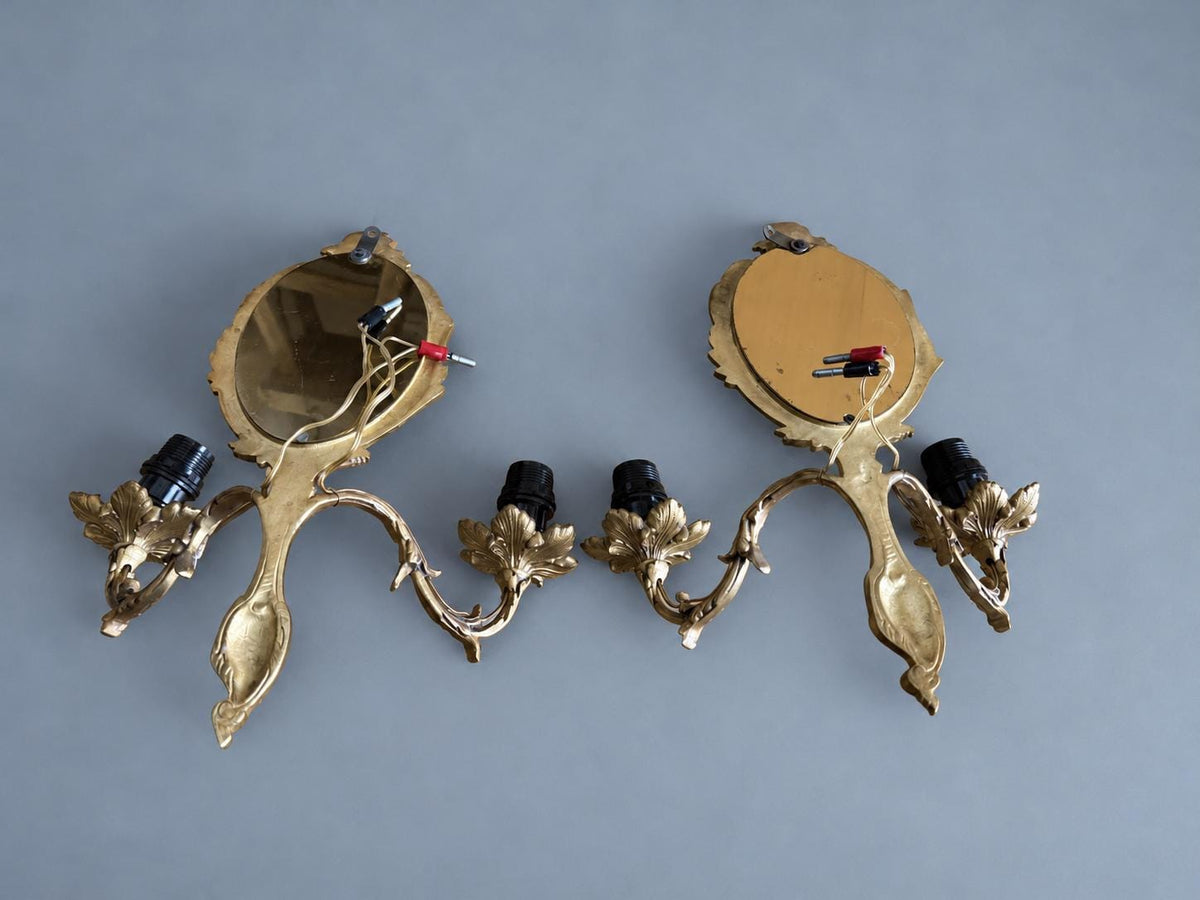 Vintage Pair of Rocaille Style Mirror Wall Sconces, Oval Bevelled Mirrors in Gilt Metal Frames, Leafy Two-Light Arms