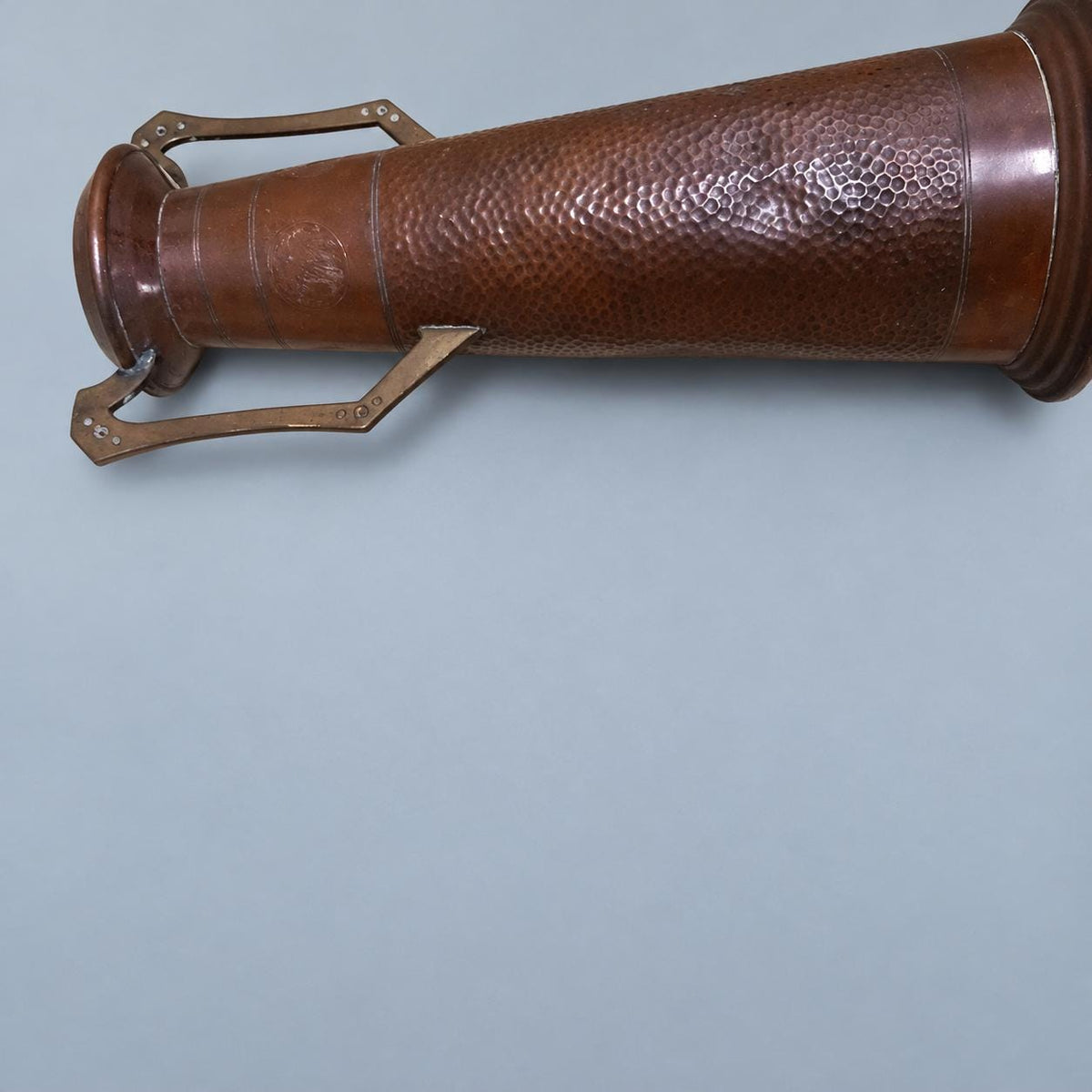 Vintage Art Nouveau Style Hammered Copper-Tone Vase with Angular Riveted Handles, Tall Tapering Form on Stepped Foot