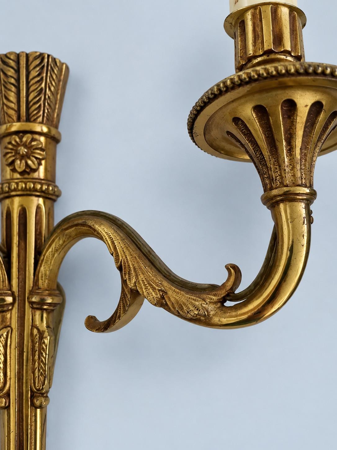 Vintage Pair of Louis XVI Style Gilt Metal Two-Arm Wall Sconces with Fluted Shaft and Rosettes