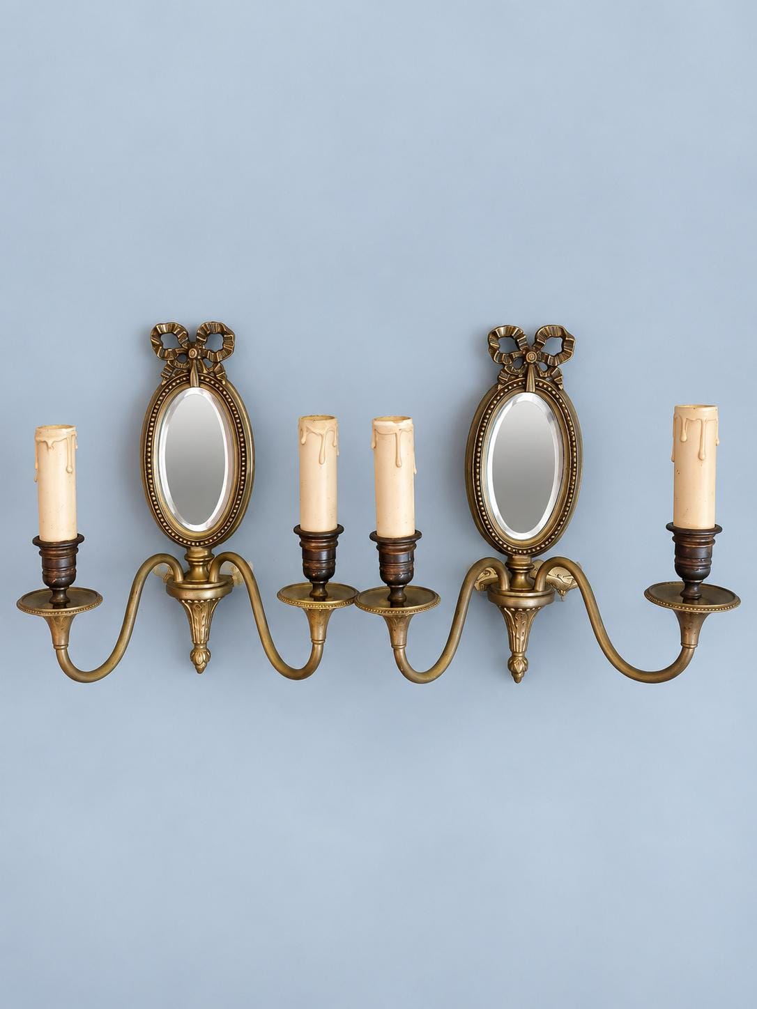 Vintage Pair of Louis XVI Style Two-Arm Wall Sconces with Oval Bevelled Mirrors and Ribbon Bows