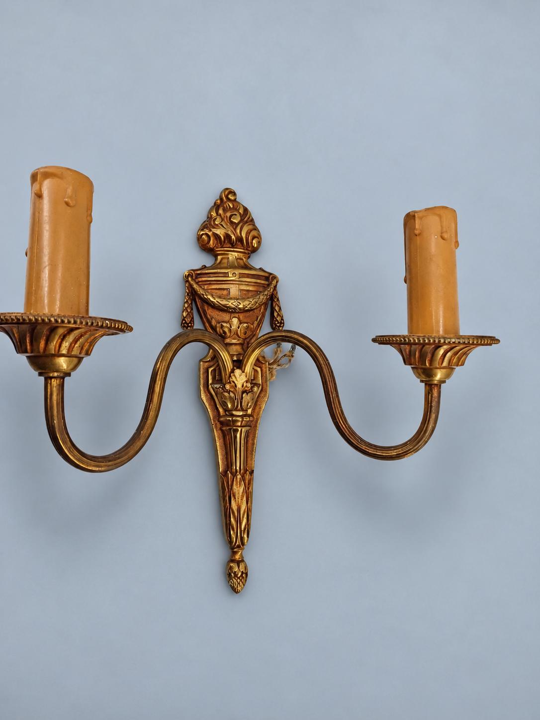 Vintage Pair of Louis XVI Style Two-Arm Gilt Metal Wall Sconces with Flaming Urns and Tasselled Swags