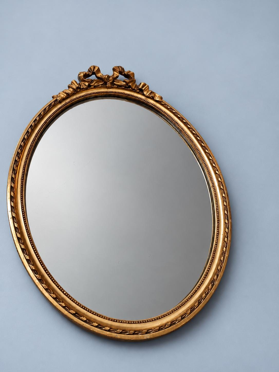 Vintage Oval Louis XVI Style Wall Mirror with Ribbon Bow Crest, Attributed 1960s, Gold-Tone Beaded Frame, 47 cm