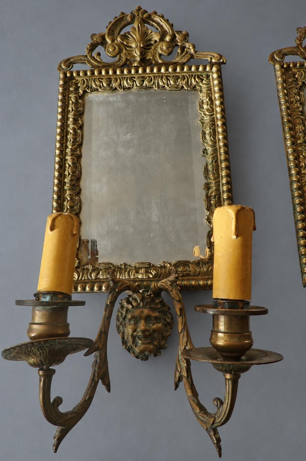 Vintage Pair of Mirror Wall Sconces with Masks, Patinated Metal Beaded Frames and Palmette Crests, Bevelled Mirrors, Two Lights Each, 41 cm