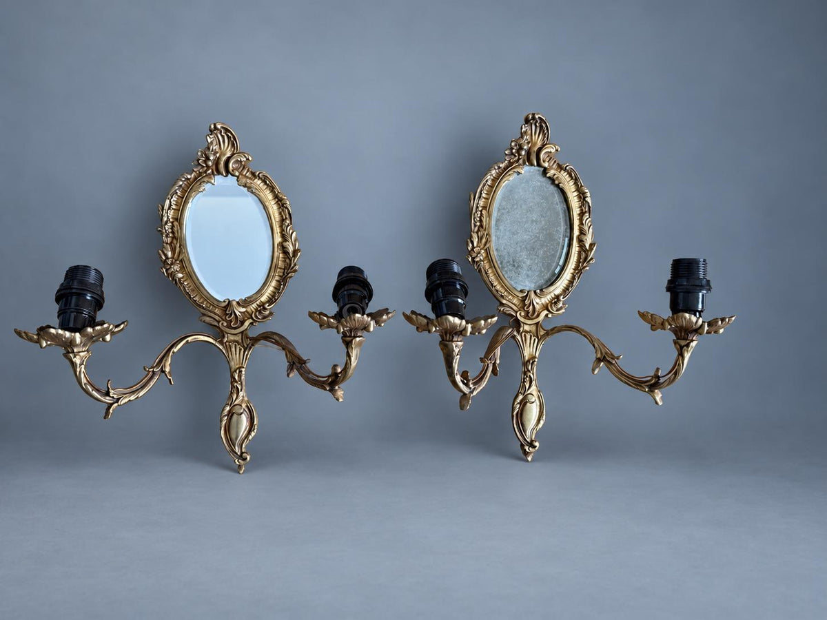 Vintage Pair of Rocaille Style Mirror Wall Sconces, Oval Bevelled Mirrors in Gilt Metal Frames, Leafy Two-Light Arms