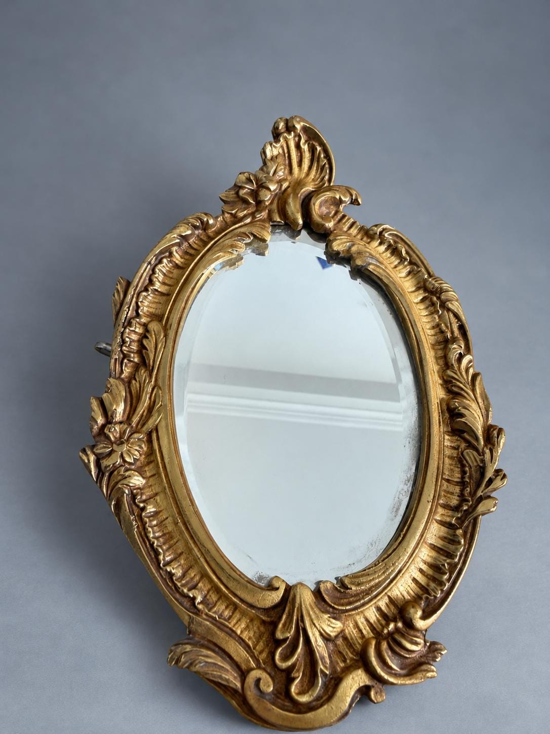 Vintage Pair of Rocaille Style Mirror Wall Sconces, Oval Bevelled Mirrors in Gilt Metal Frames, Leafy Two-Light Arms