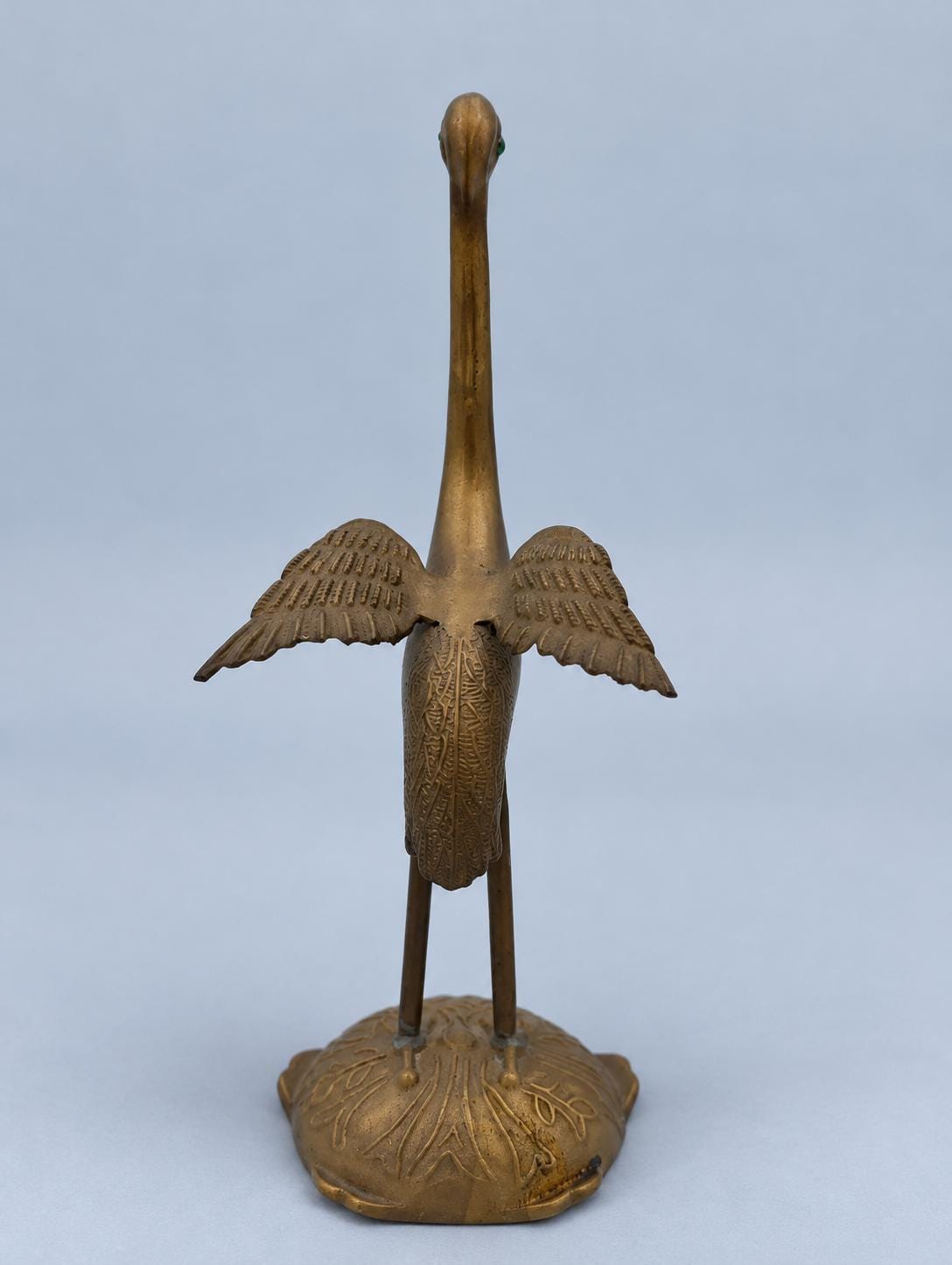 Vintage Brass Crane Figurine with Spread Wings and Green Eyes, Marked Portugal, Engraved Feather Detail on Leaf-Cast Base, 24 cm