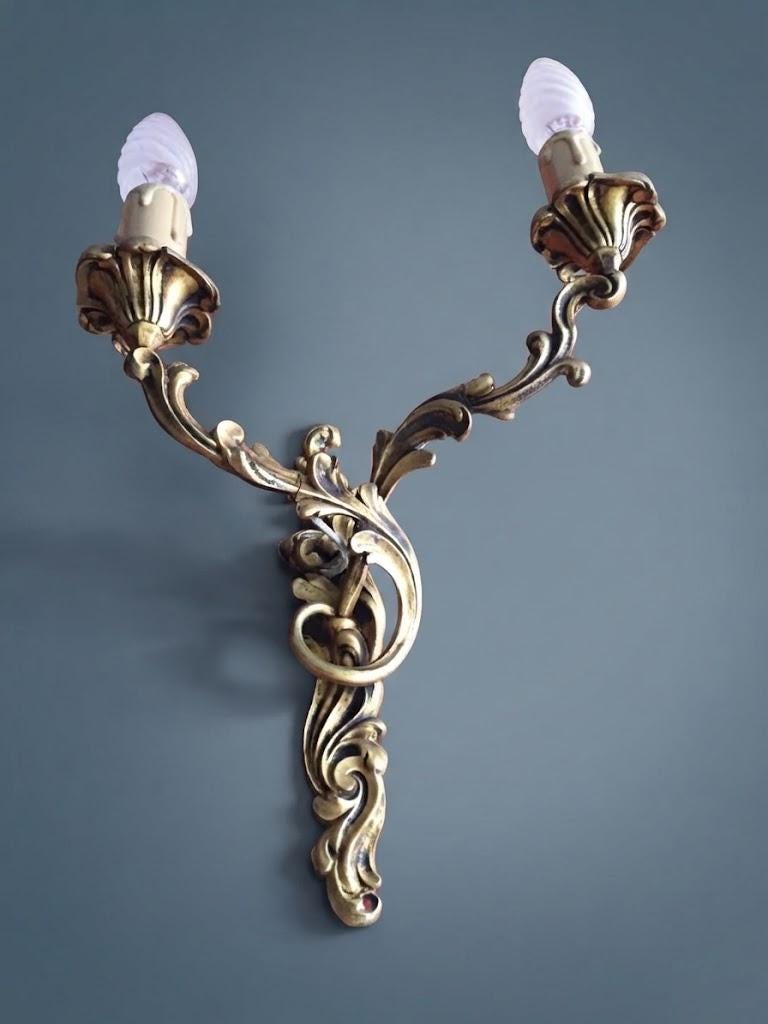 Pair of Vintage 1970s Bronze Louis XV Style Wall Sconces, Asymmetric Two-Arm Rocaille Design with Fluted Cups, Mirrored Candle Lights