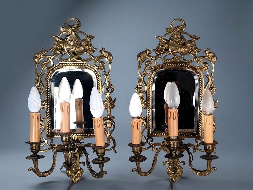 Pair of Antique Bronze Mirrored Wall Sconces, Three-Light Girandoles with Rabbits, Winged Bird Crest and Beveled Glass, 1890s
