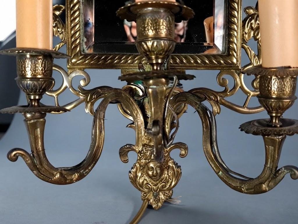 Pair of Antique Bronze Mirrored Wall Sconces, Three-Light Girandoles with Rabbits, Winged Bird Crest and Beveled Glass, 1890s