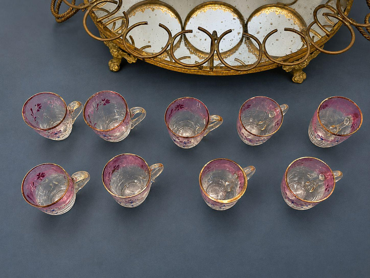 Antique Napoleon III Liqueur Set, Two Cranberry Enameled Glass Decanters and Cordial Glasses on Gilt Brass Mirrored Tray Stand