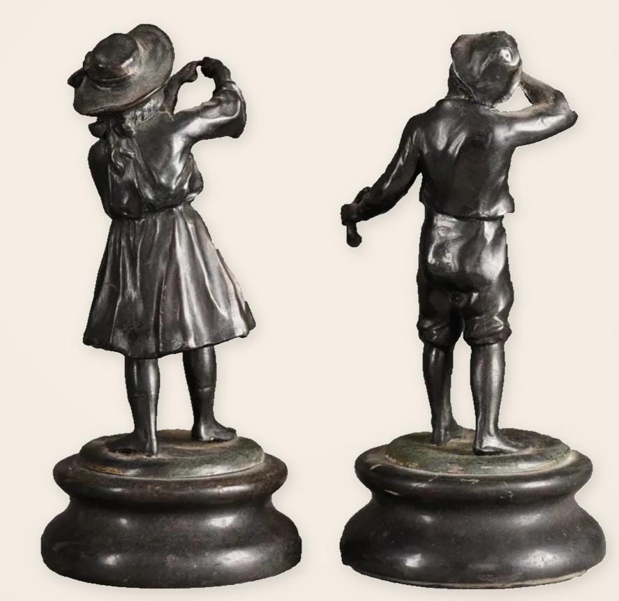 Pair of Antique Bronze Figures of Country Children, Girl in Bonnet and Boy Shading His Eyes, on Turned Bases, circa 1900