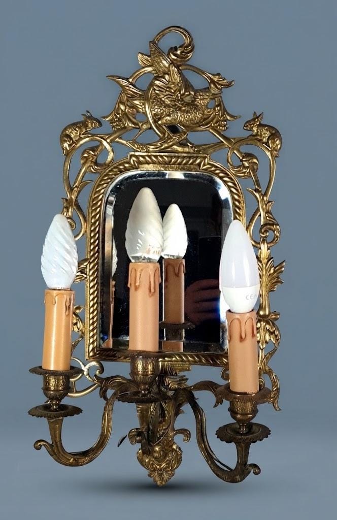 Pair of Antique Bronze Mirrored Wall Sconces, Three-Light Girandoles with Rabbits, Winged Bird Crest and Beveled Glass, 1890s