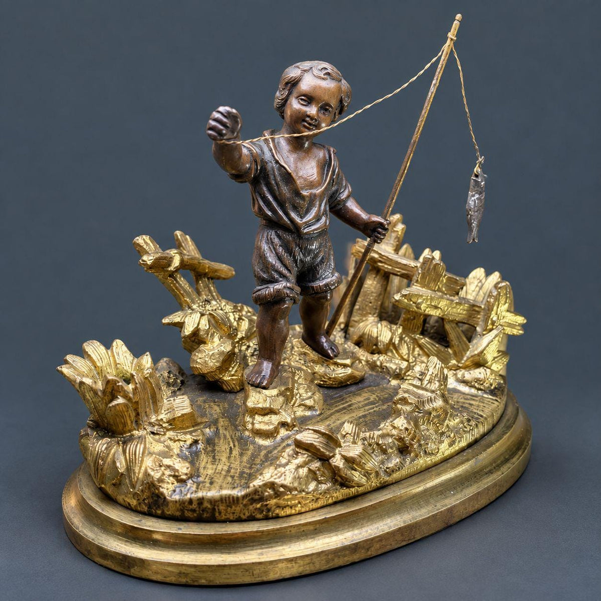Antique 19th Century Gilt Bronze Match Holder, Young Boy Fishing with Rod and Fish on Reed-Covered Bank, Smoker’s Pyrogene
