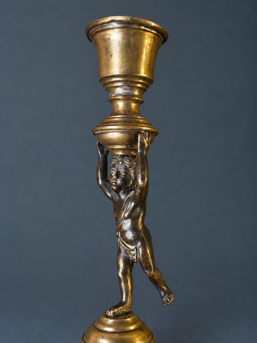 Pair of Antique Restauration Era Cherub Candlesticks, Bronze Putti Holding Brass Cups on Lion Paw Tripod Bases, 19th Century